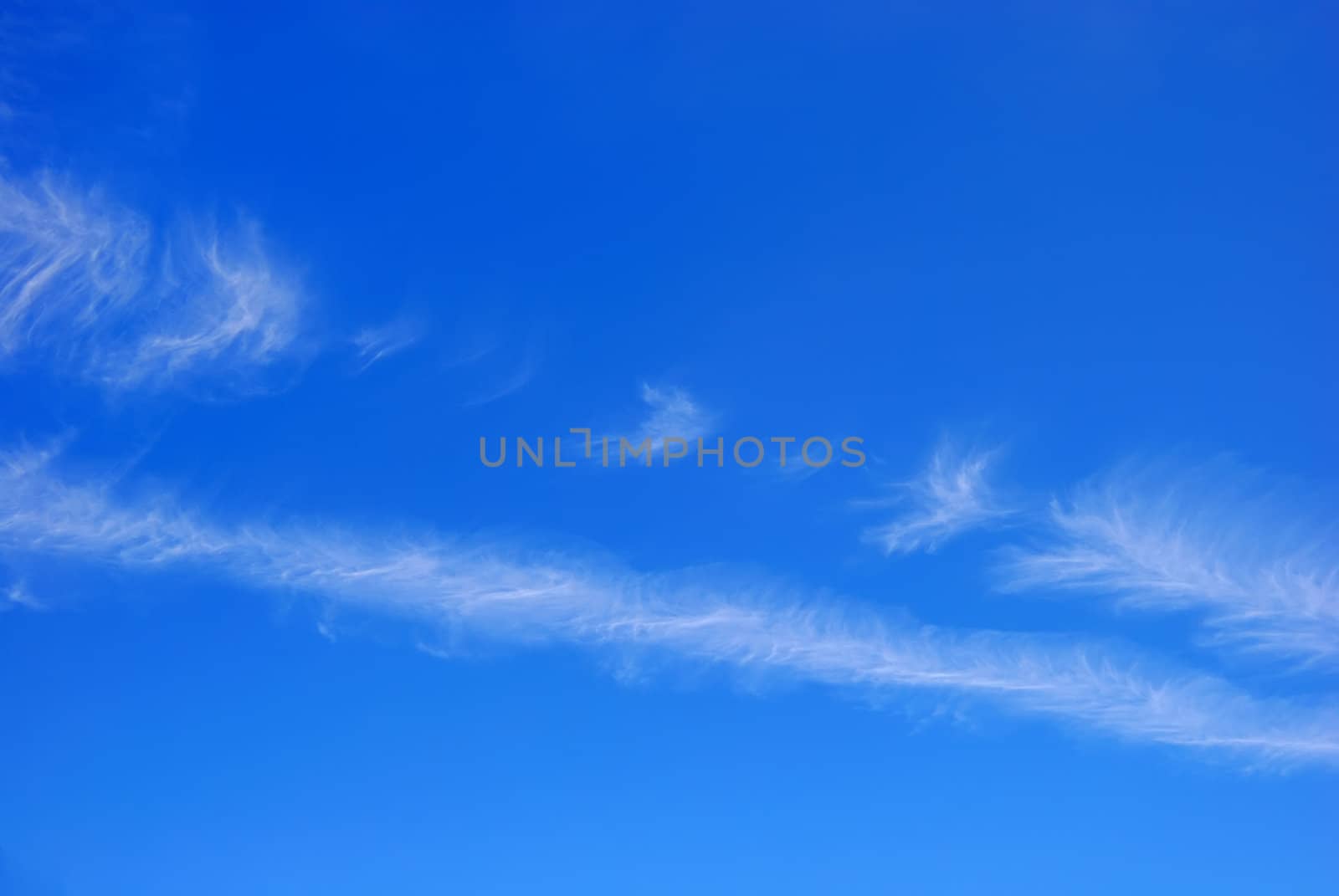 Blue sky with two diagonal white cloud stripes.