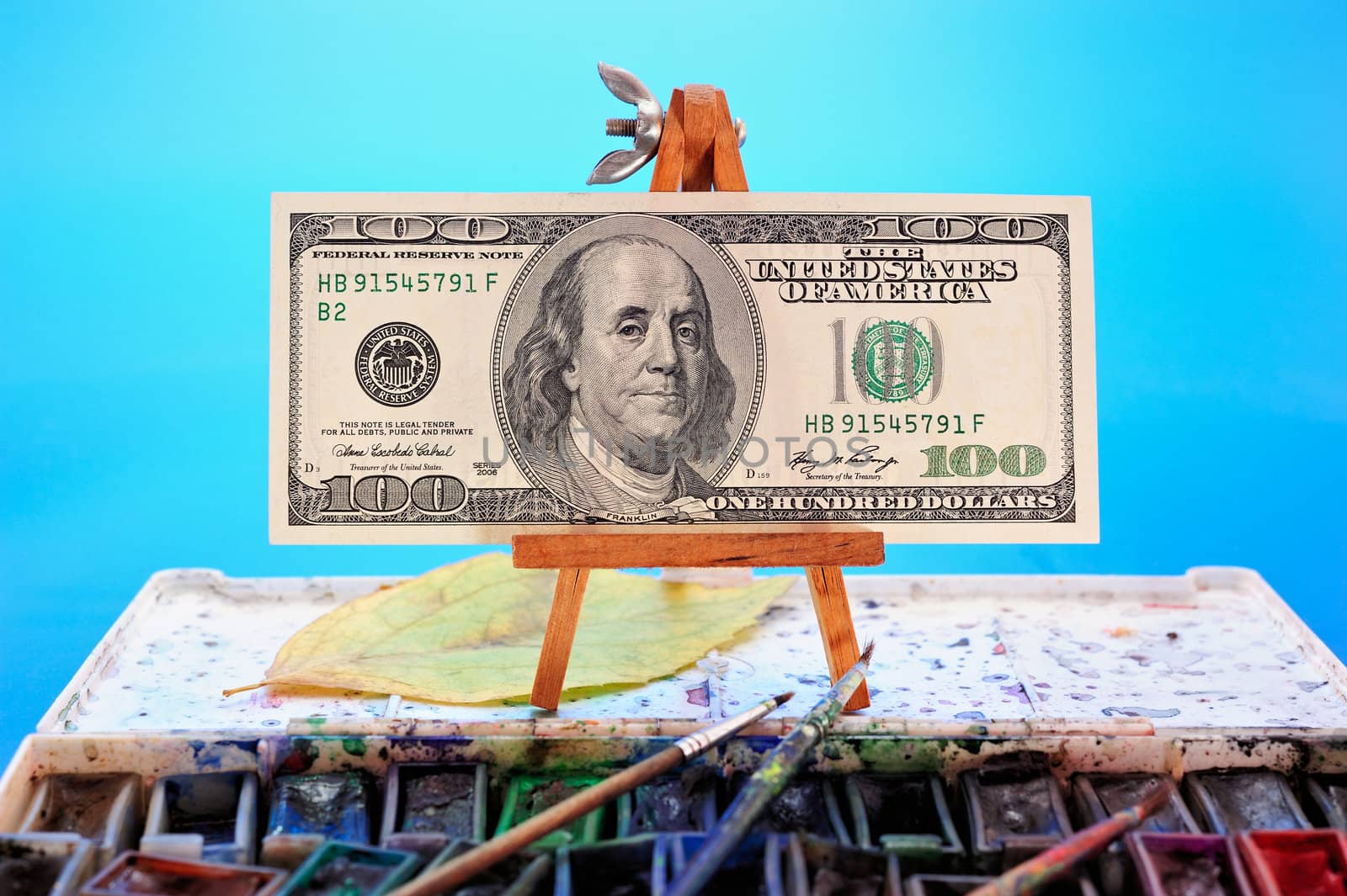 Image of dollar bill as a picture on a miniature easel