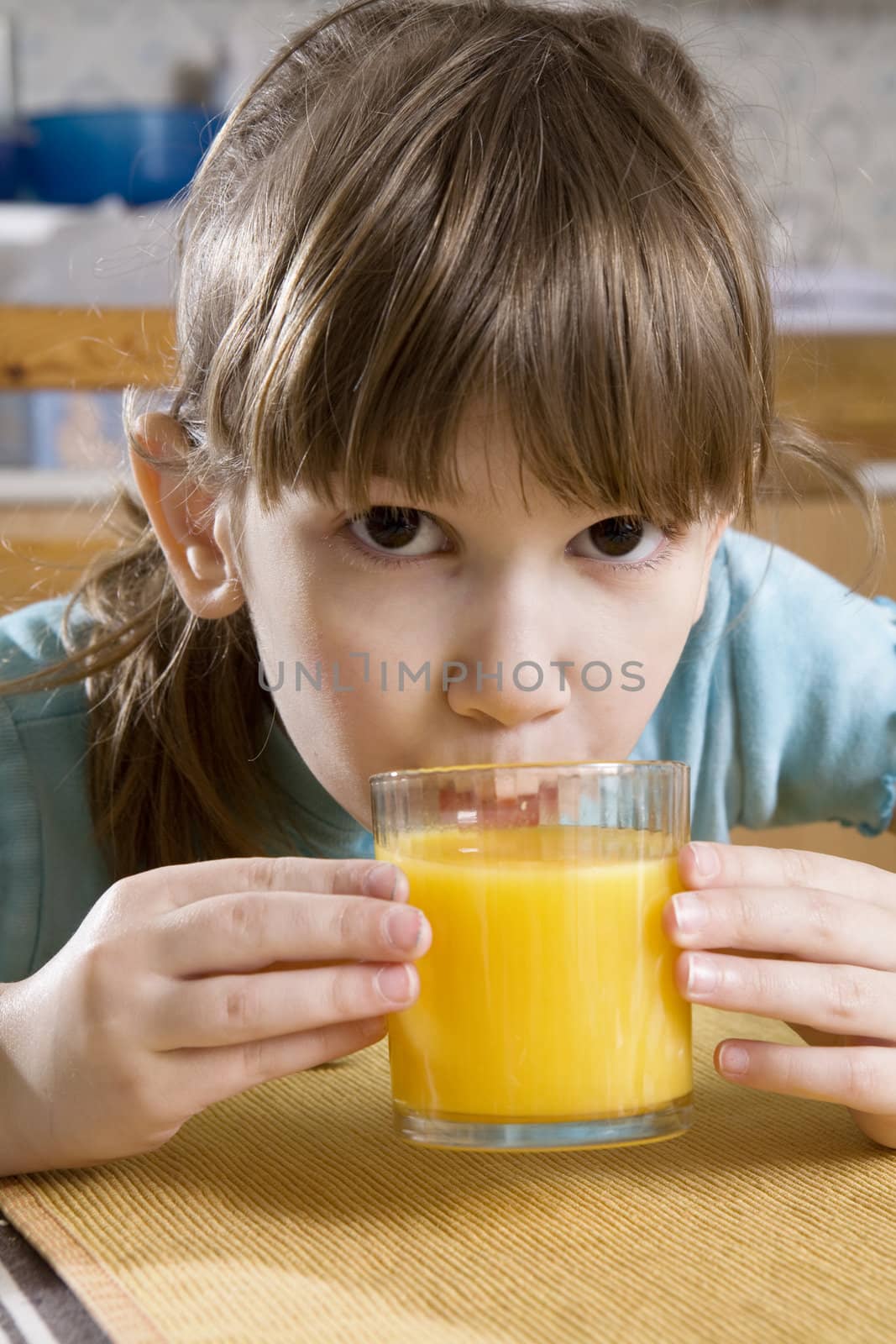 little cute girl seven years old drink orange juice
