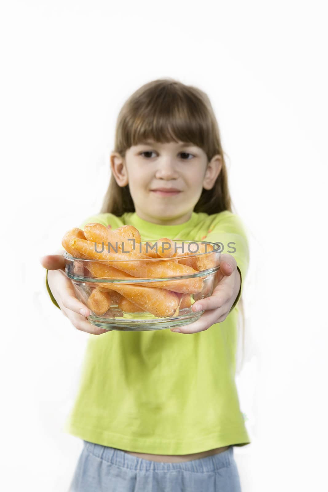 little cute girl holding carrot  in glasses plate