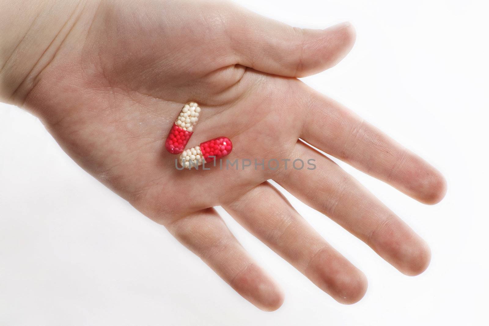 pills in a hand on a white background