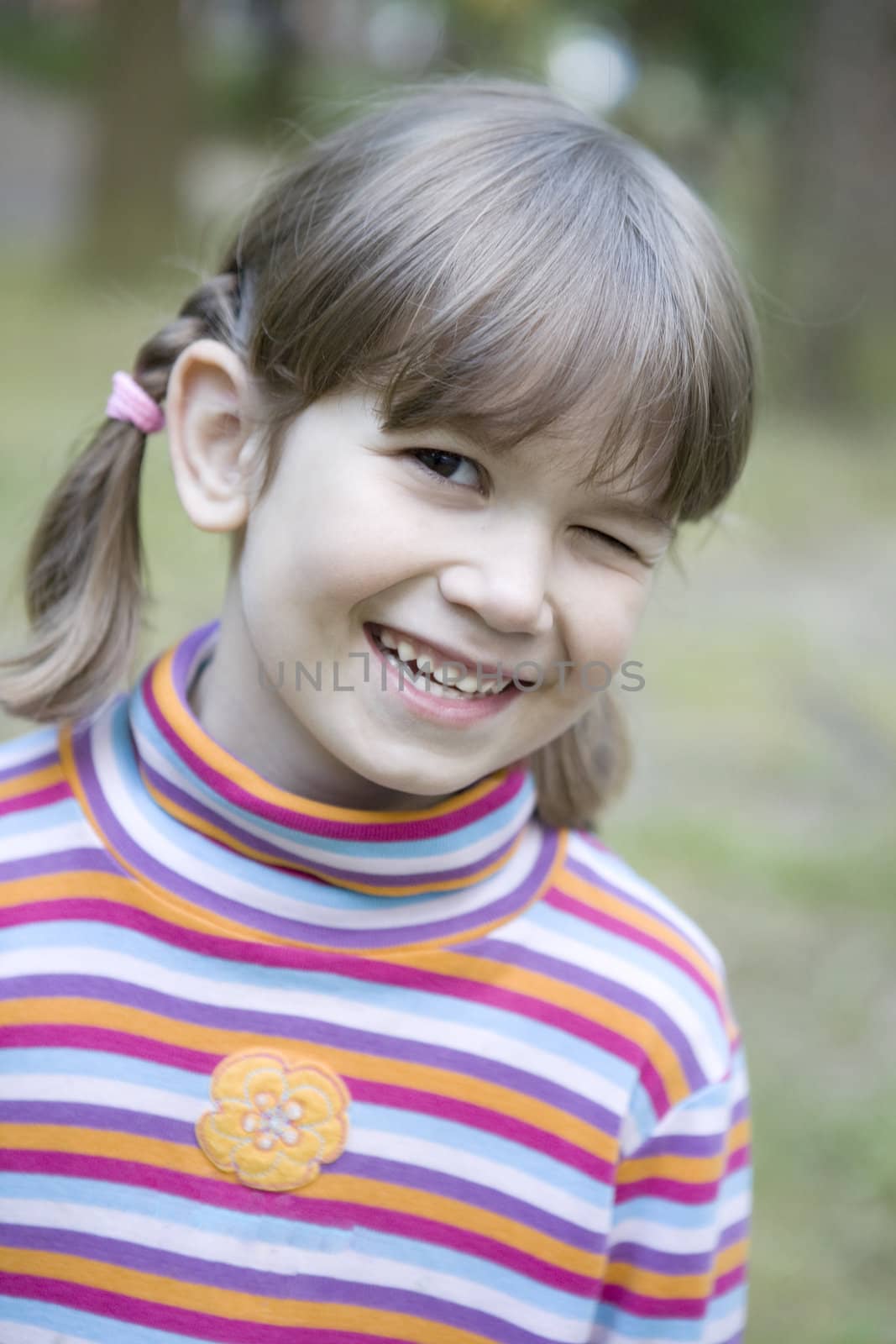 close up portrait cute smiling winking girl with funny expression