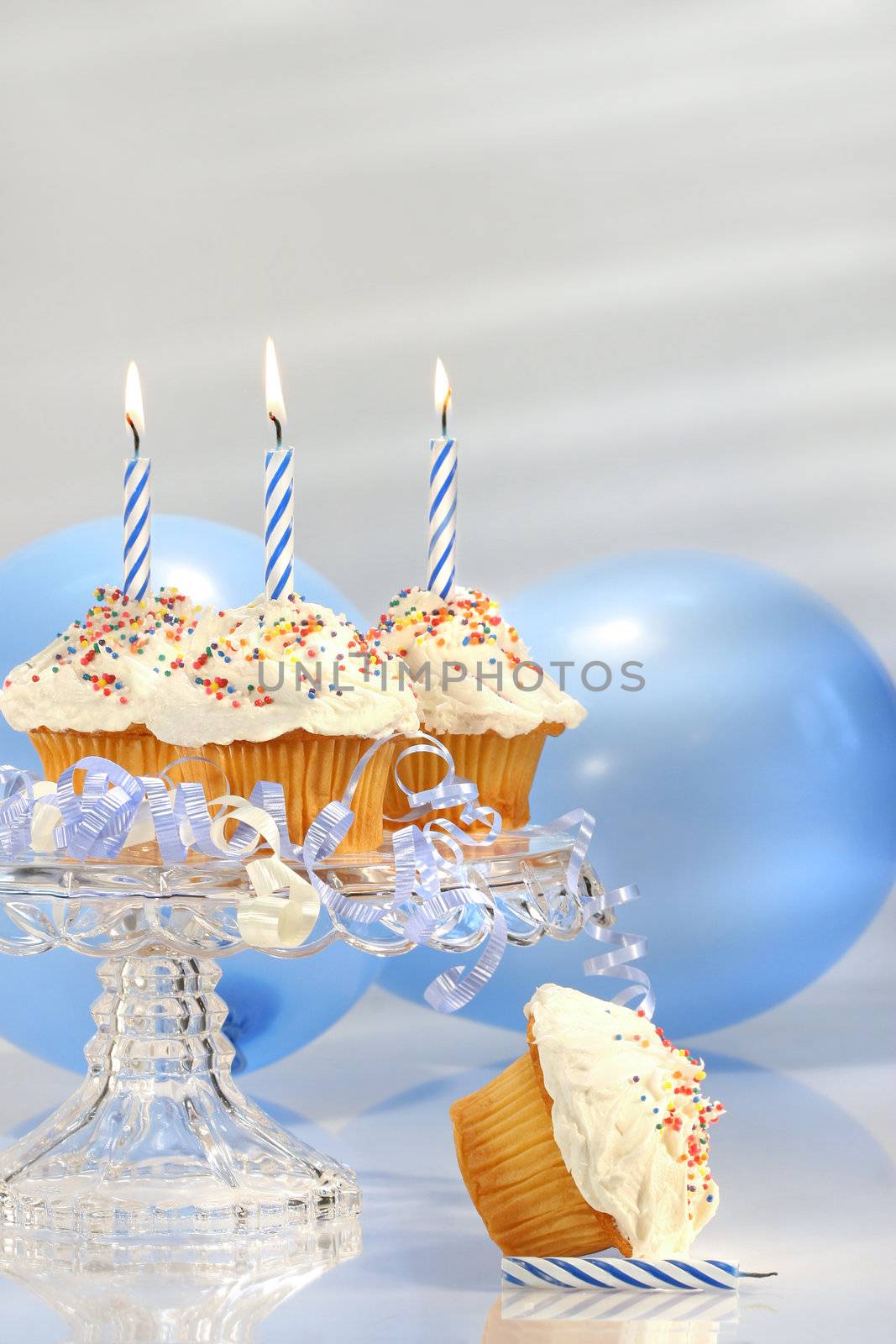 Birthday cupcakes with blue candles by Sandralise