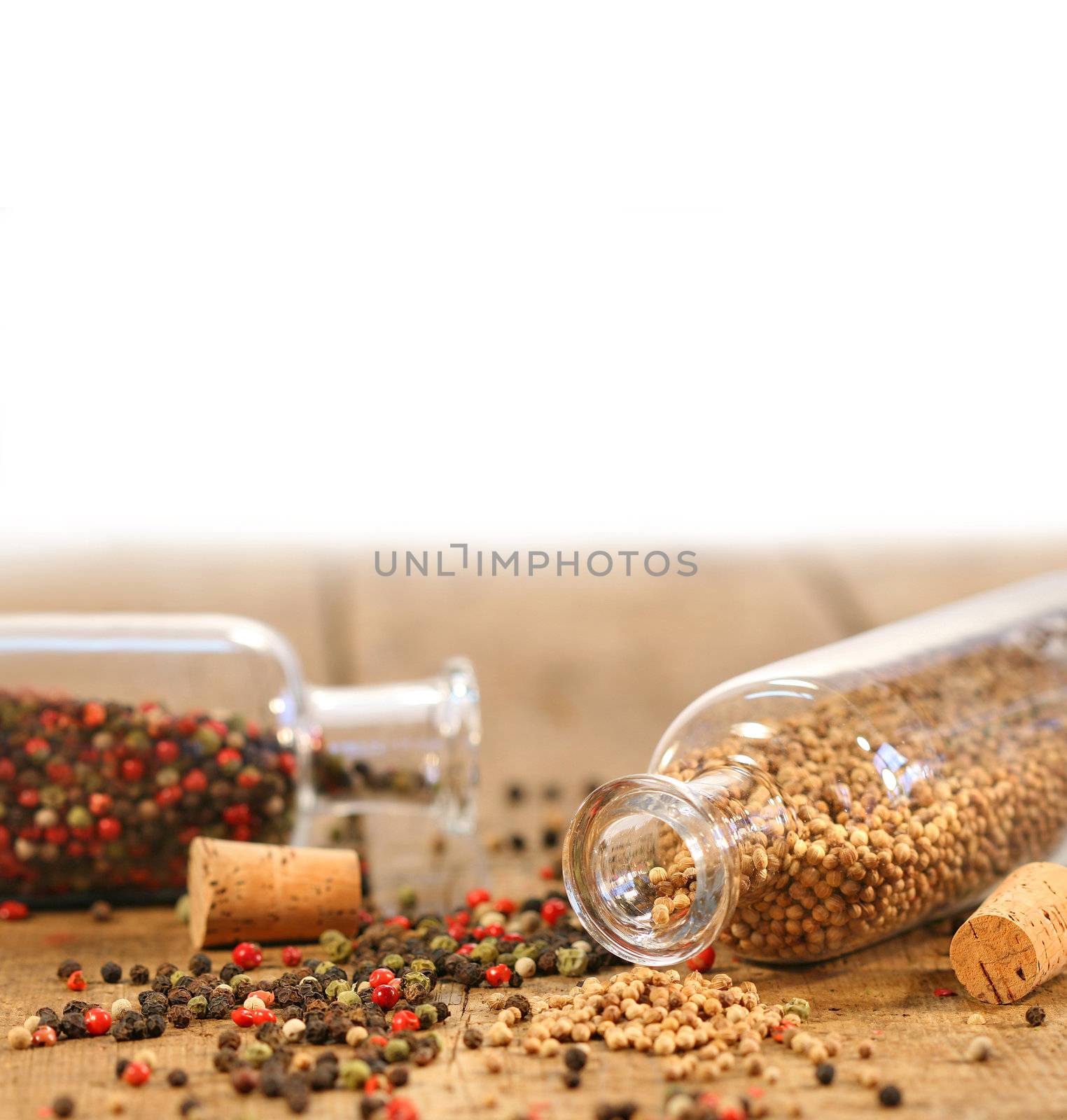 Bottles of spices on rustic wood table 