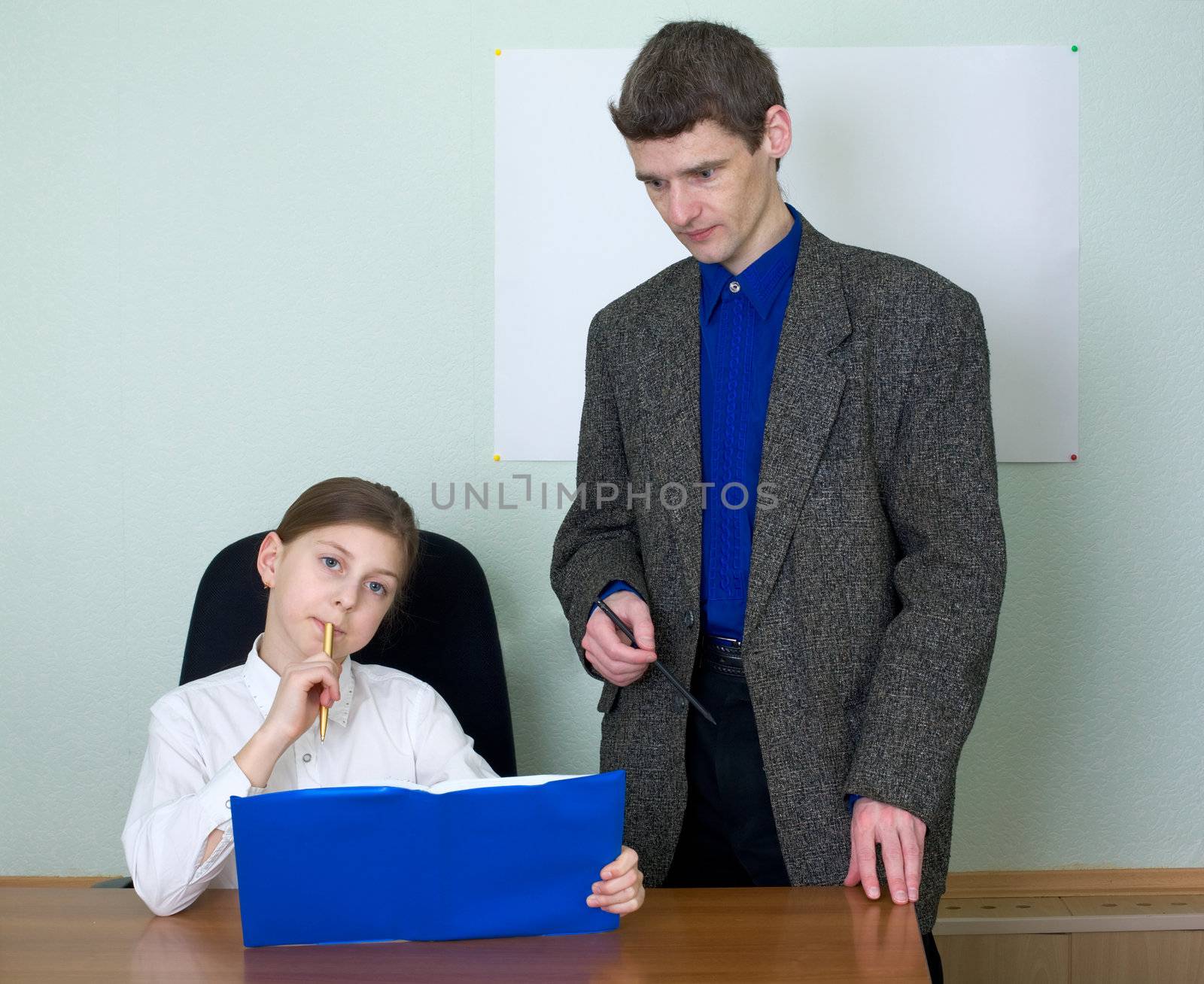 Teacher in a suit and schoolgirl with book