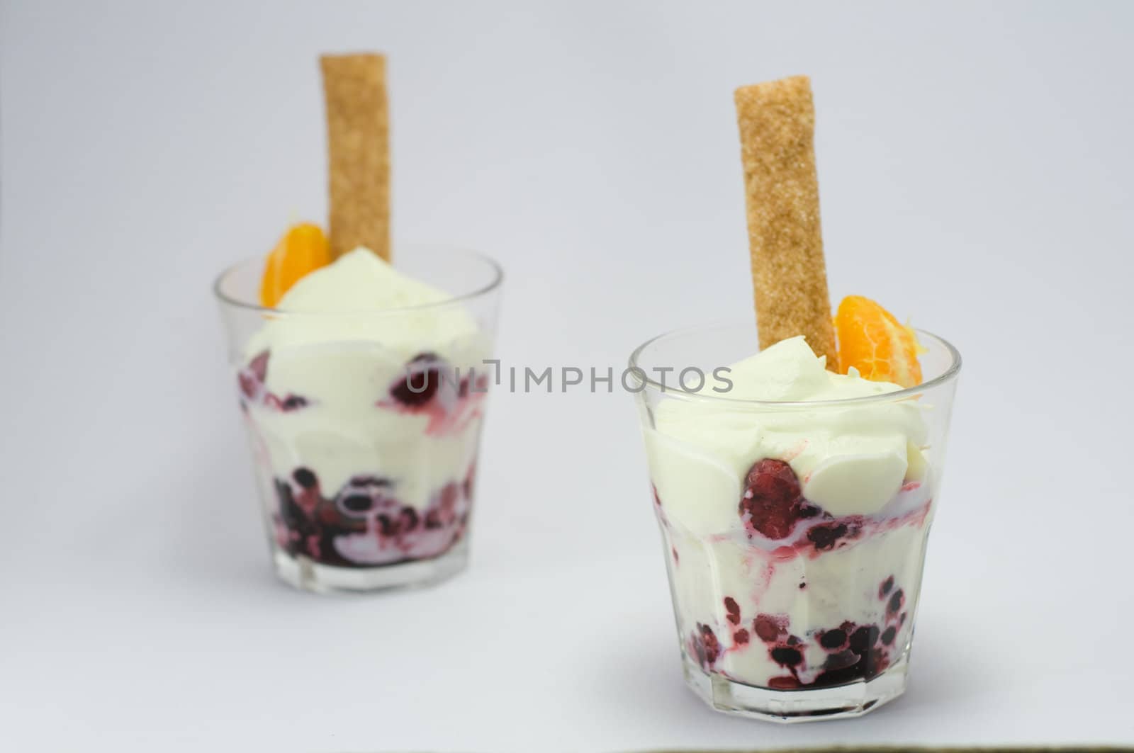 Dessert with whipped cream in a glass on a white background