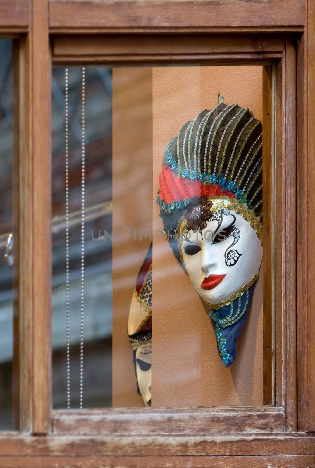 Venetian masks across old window