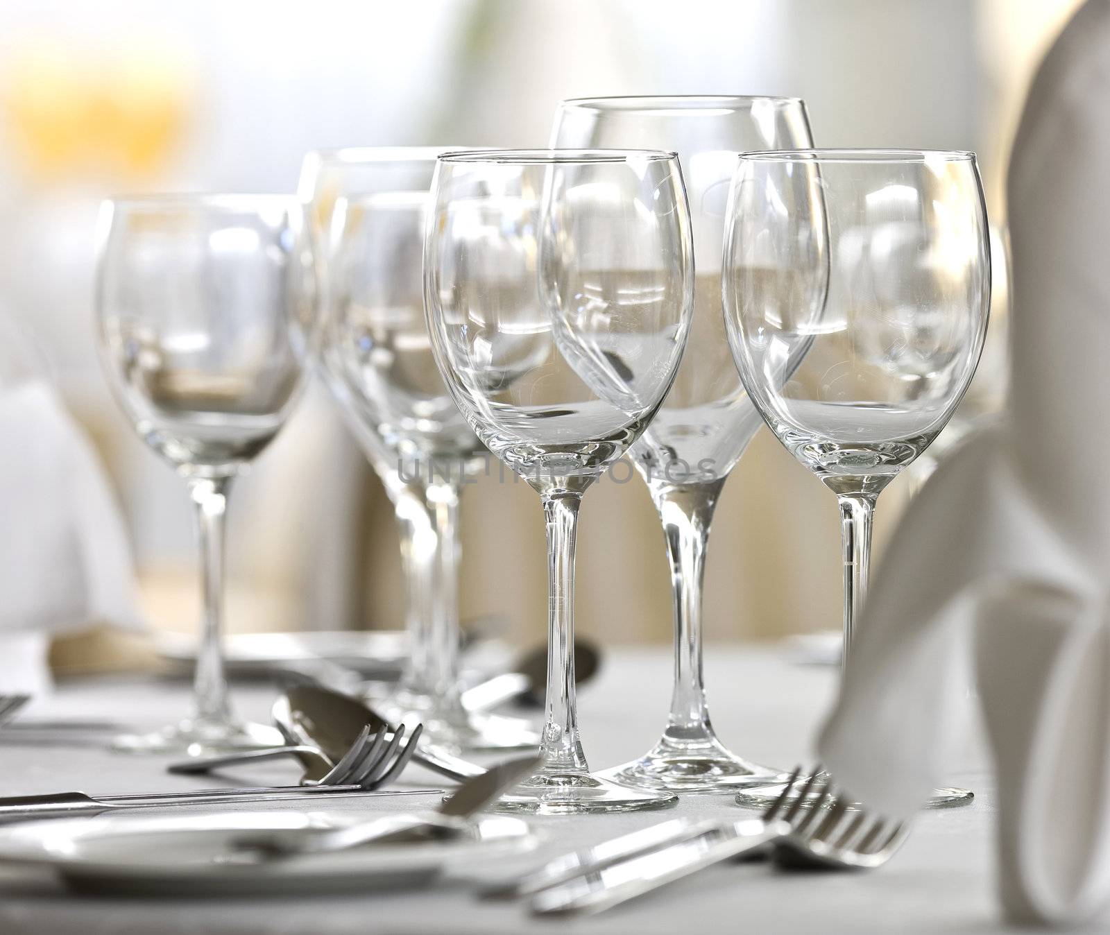 Glasses, fork, spoon, plate and knife on a table