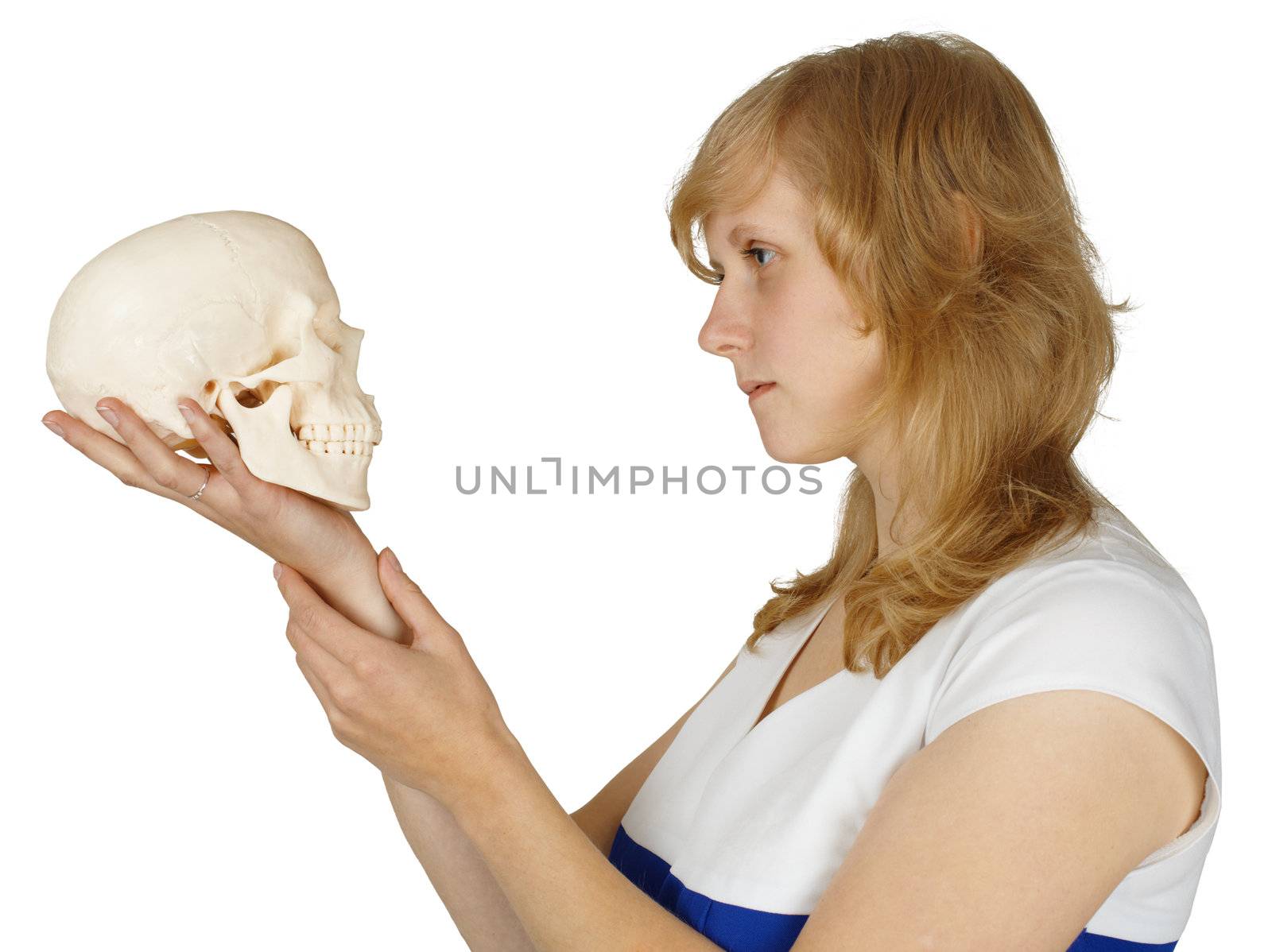 A woman examines a human skull isolated on white background