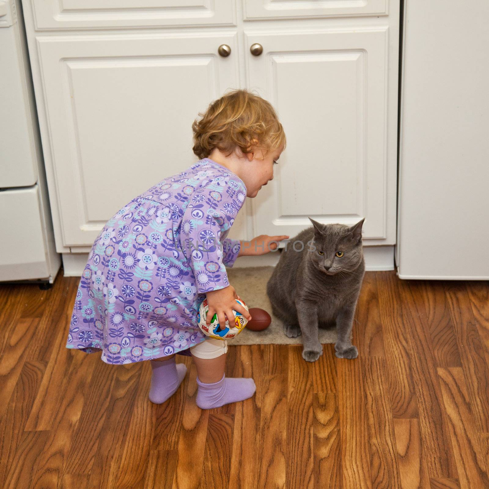 Girl playing with cat by melastmohican