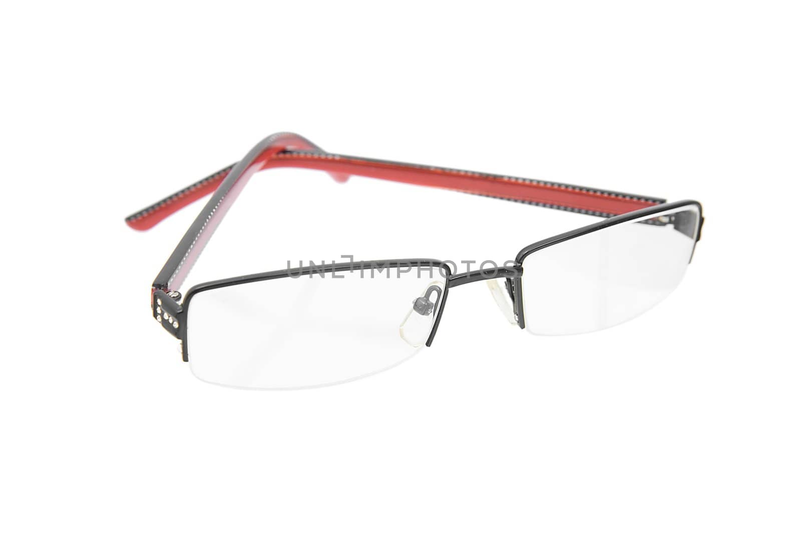 glasses with a red and black frame lie on a white table