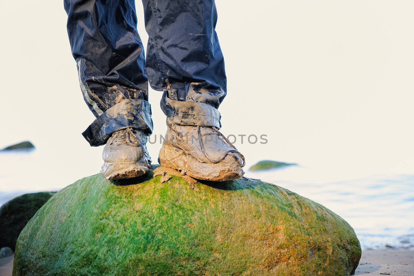 Dirty boots on the cliff on the sea shore