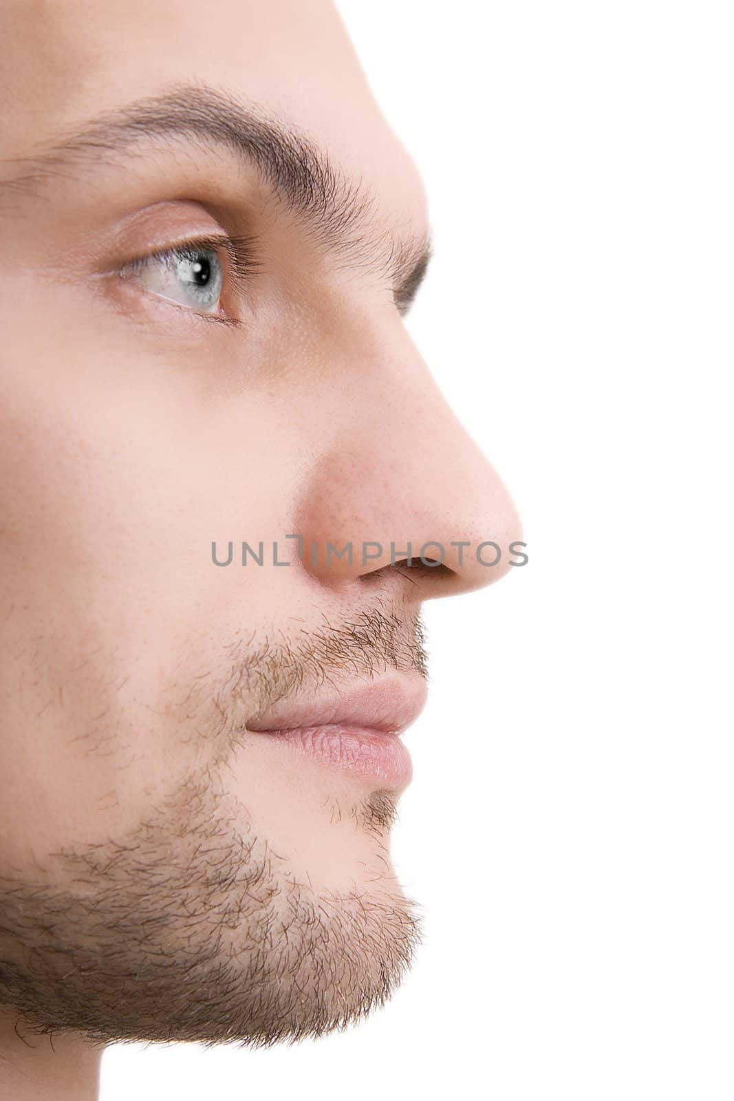 Man's face with blue eyes in a profile on a white background