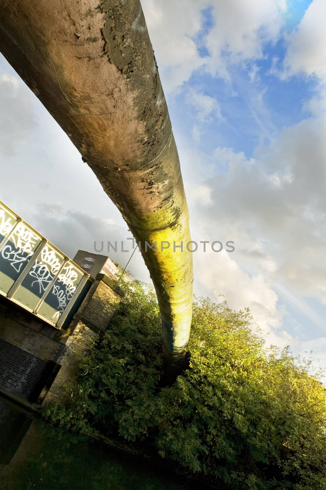 London. Regent Canal. Dirty pipe above canal