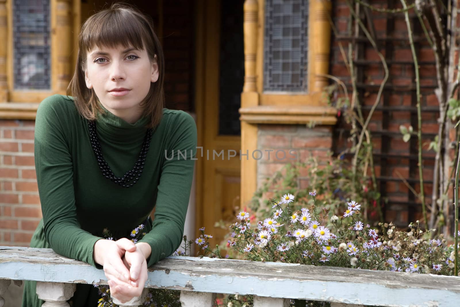 young attractive woman standing in garden by elenarostunova