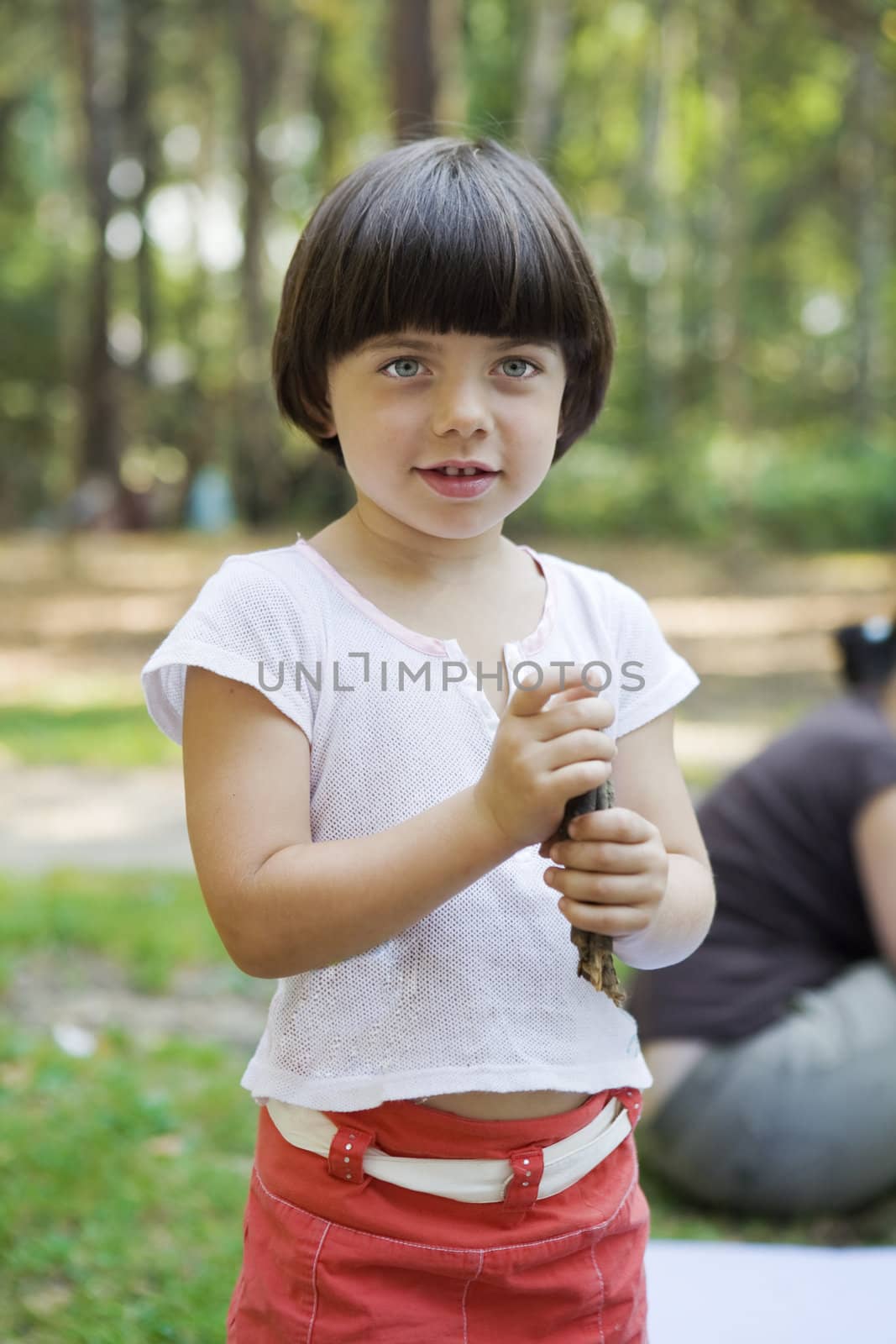 little cute pensive girl five years old standing on the park  by elenarostunova