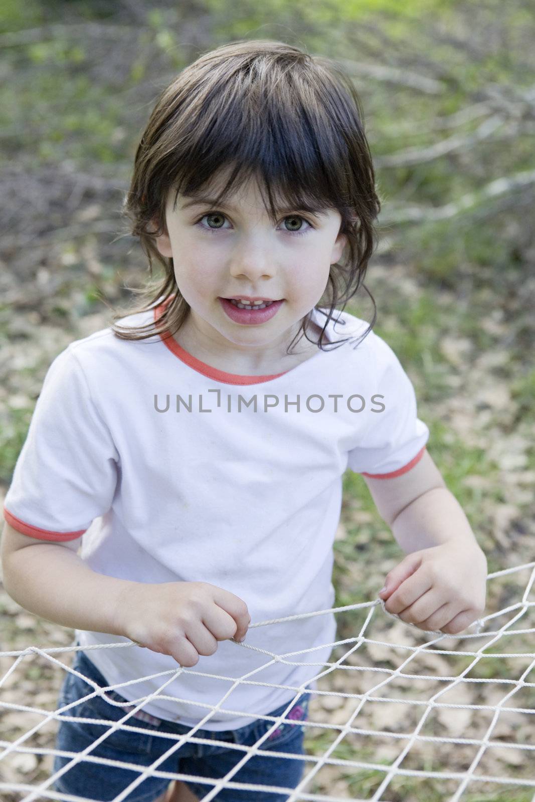 portrait of young adorable girl standing in park
