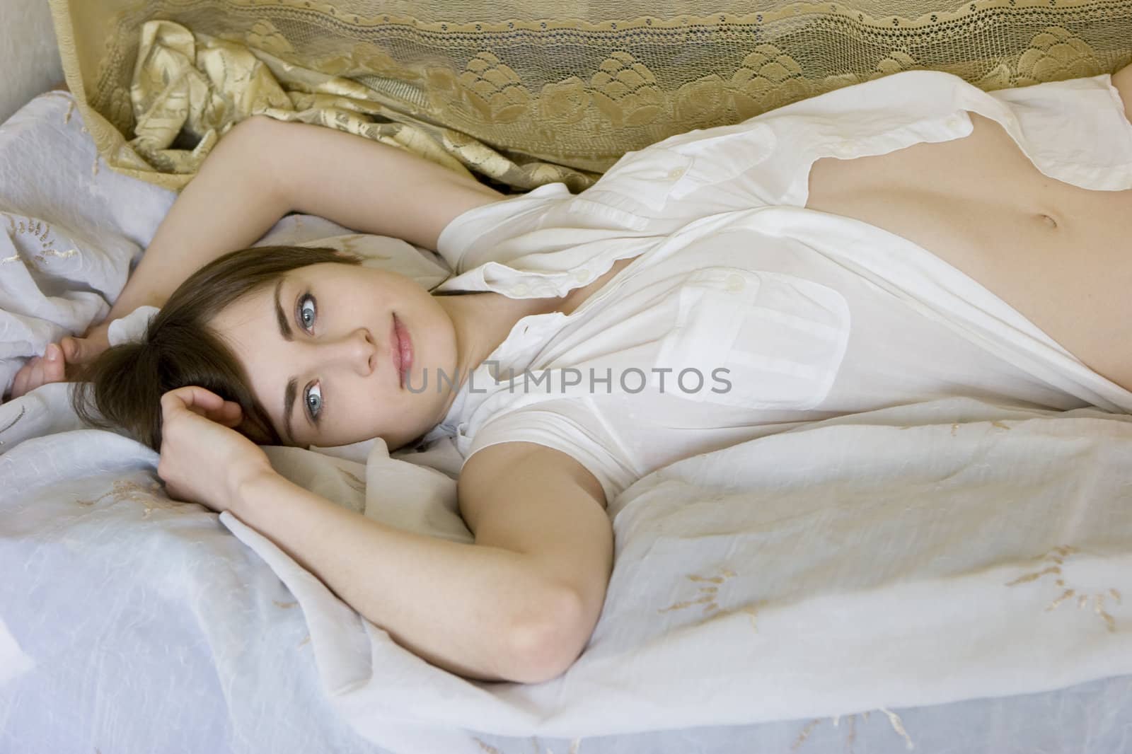attractive smiling woman lying on bed by elenarostunova