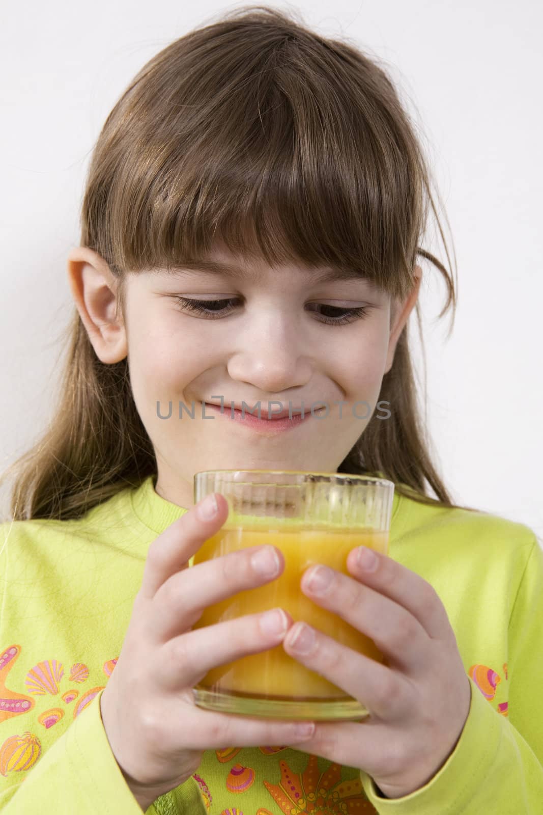 little cute girl seven years old drink orange juice by elenarostunova