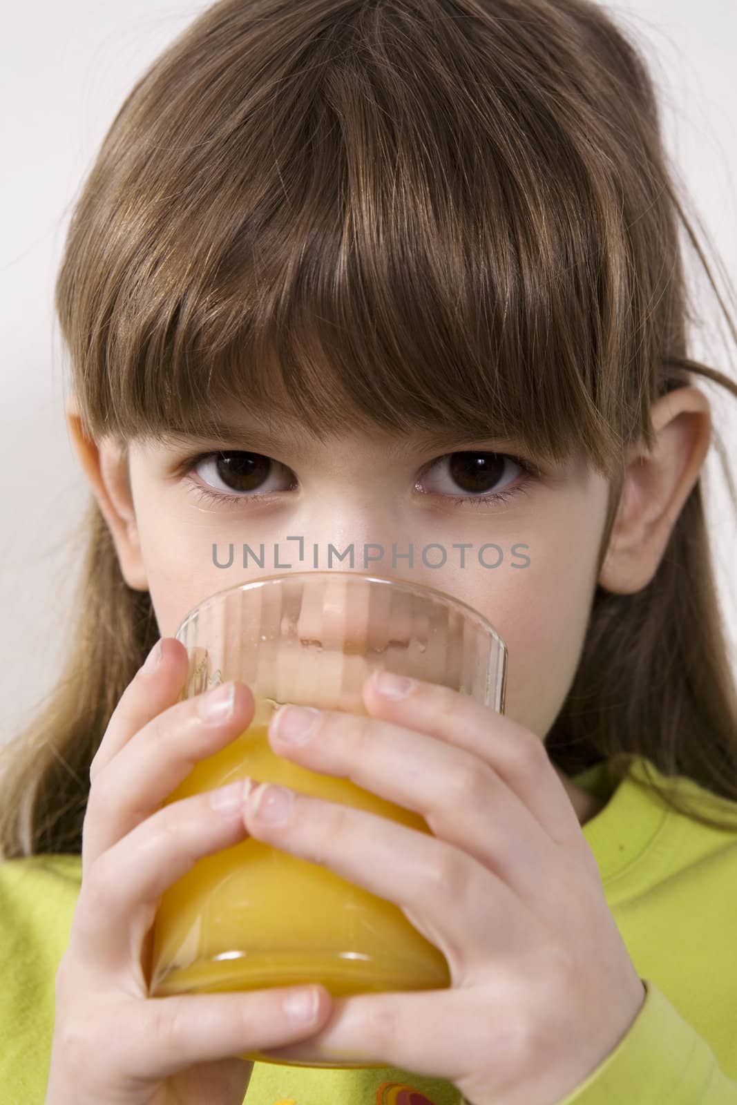 little cute adorable serious girl seven years old drink orange juice
