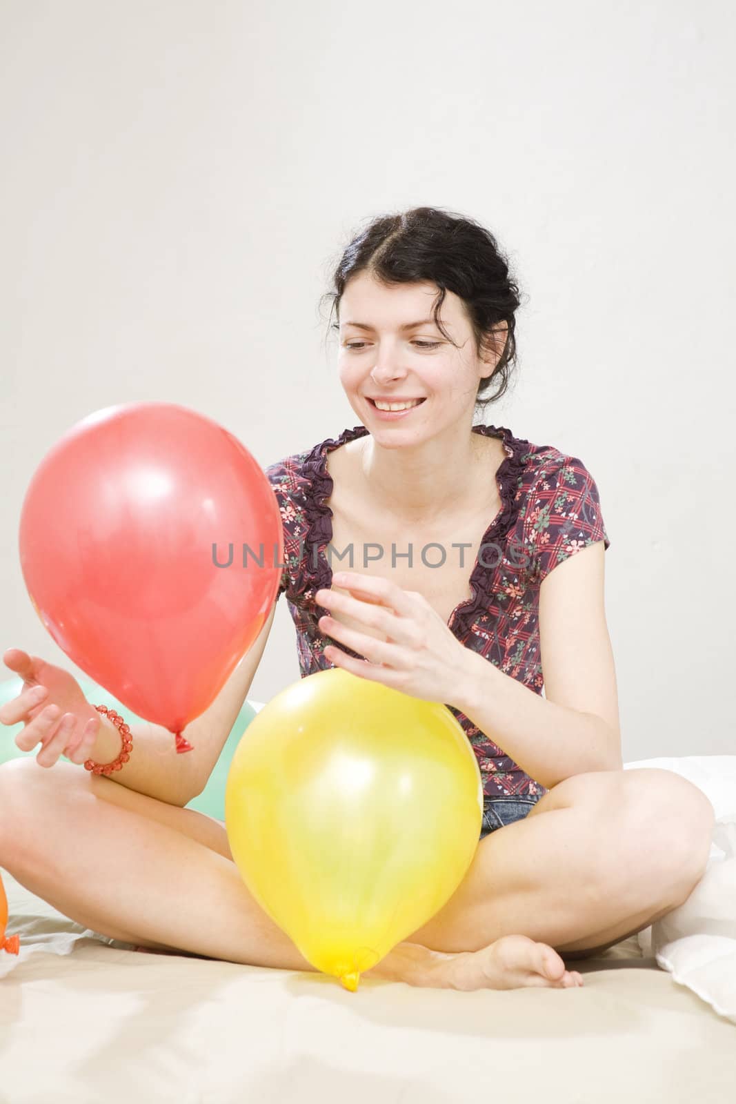 attractive woman doing exercise with balloon by elenarostunova