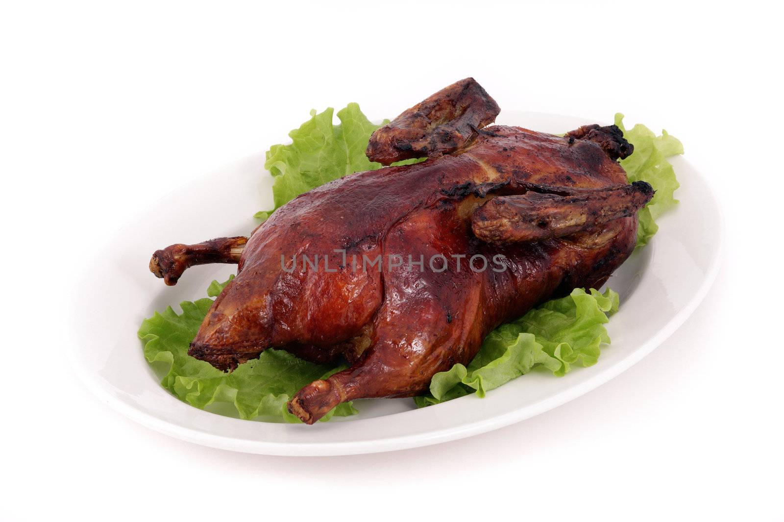 Fried duck on a dish with salad