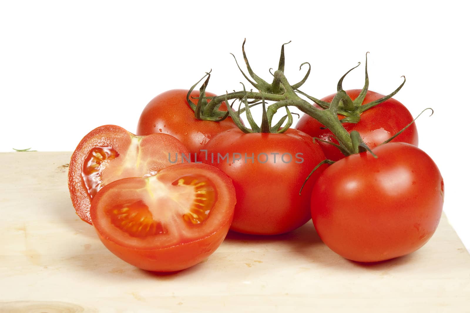 Fresh tomatoes isolated on white by ladyminnie