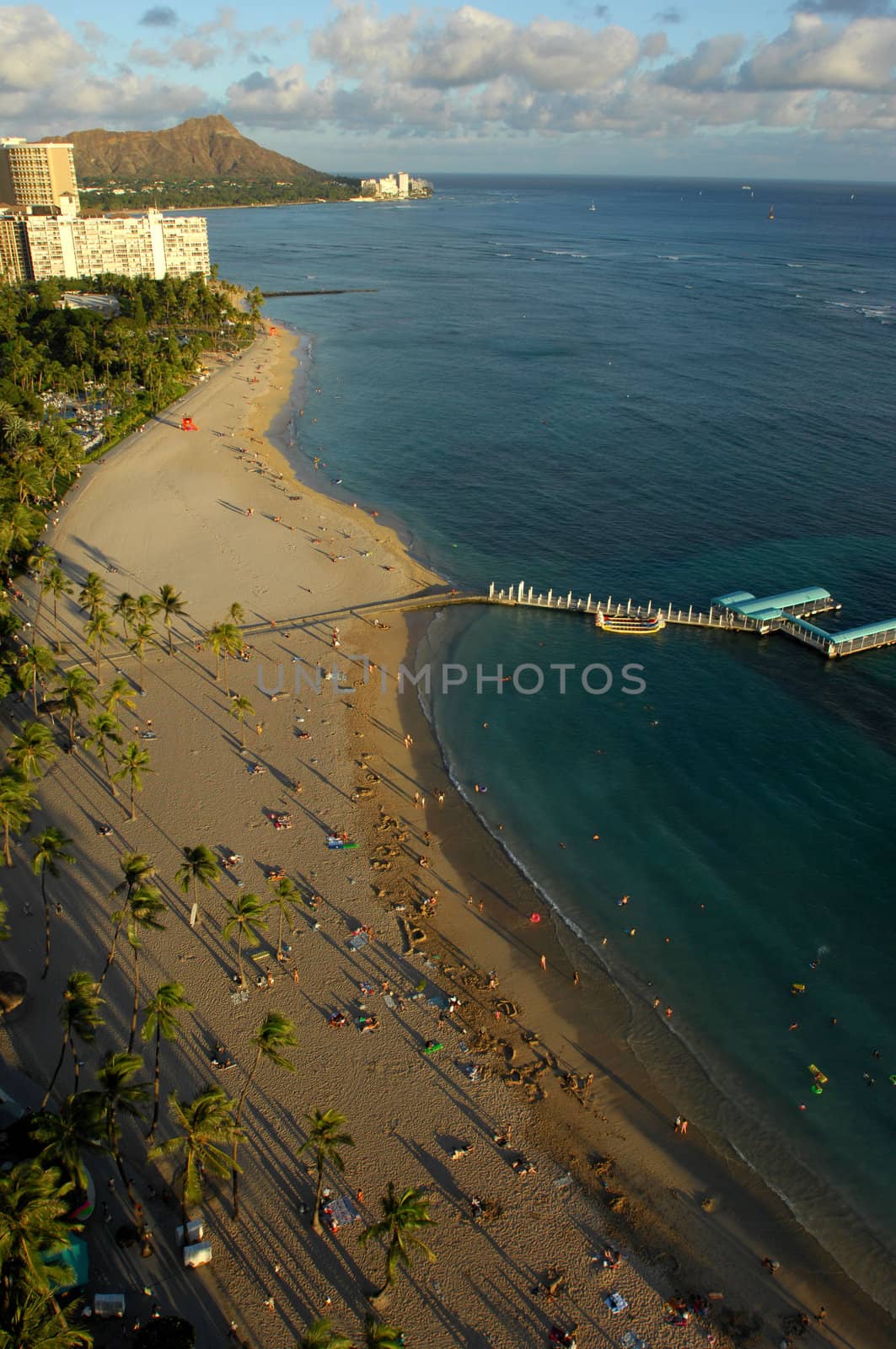 Looking down at Waikiki Beach in Honolulu, Hawaii and across to Diamond Head as the sun sets.