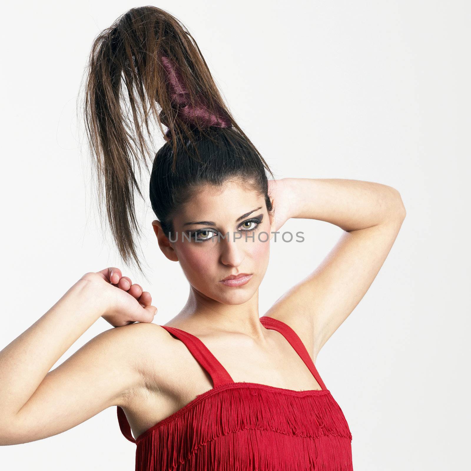 Pretty girl dressed in red is doing stretching