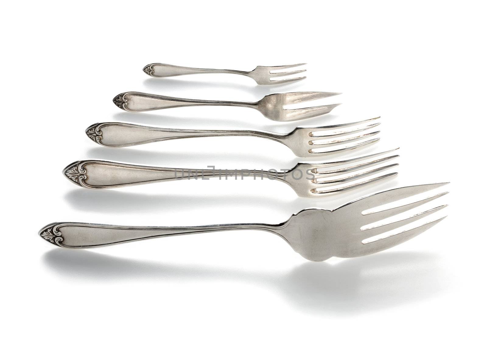 Silver forks set setout on a white background