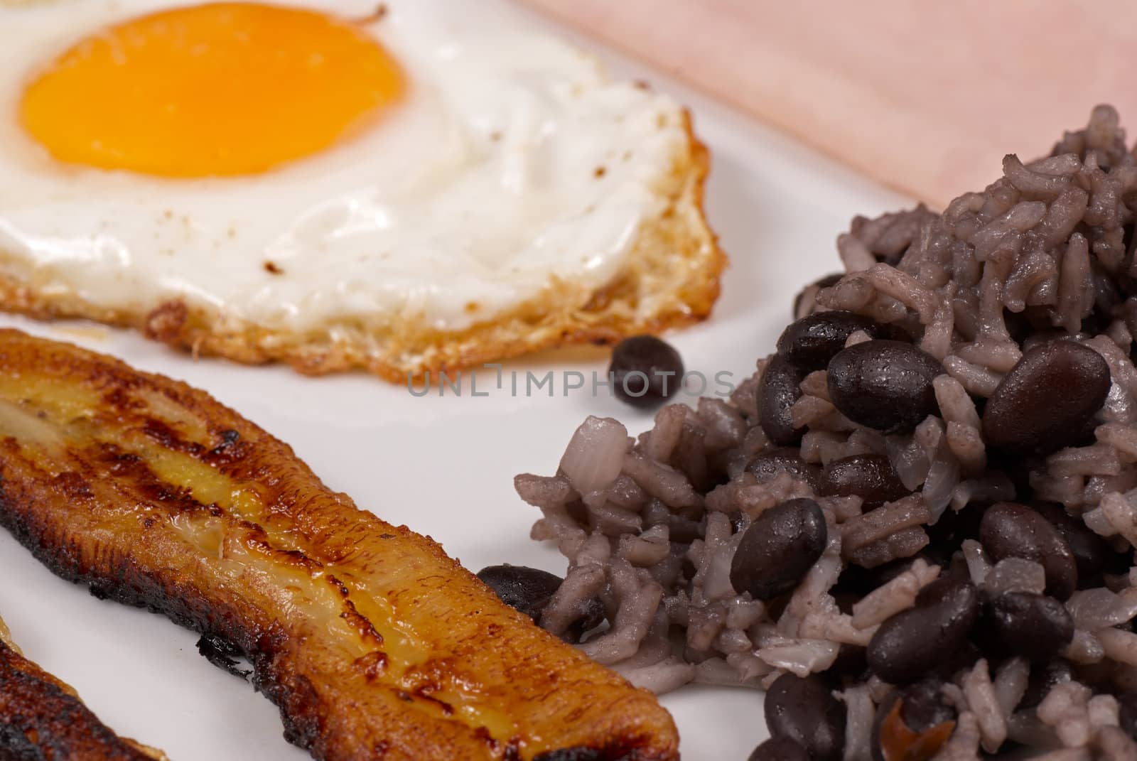 Hearty central american breakfast, gallo pinto with ham and egg