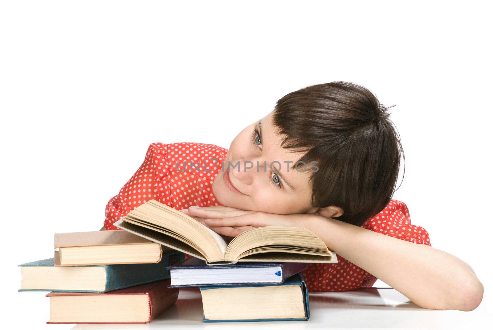 Young women overlie on the book, white background