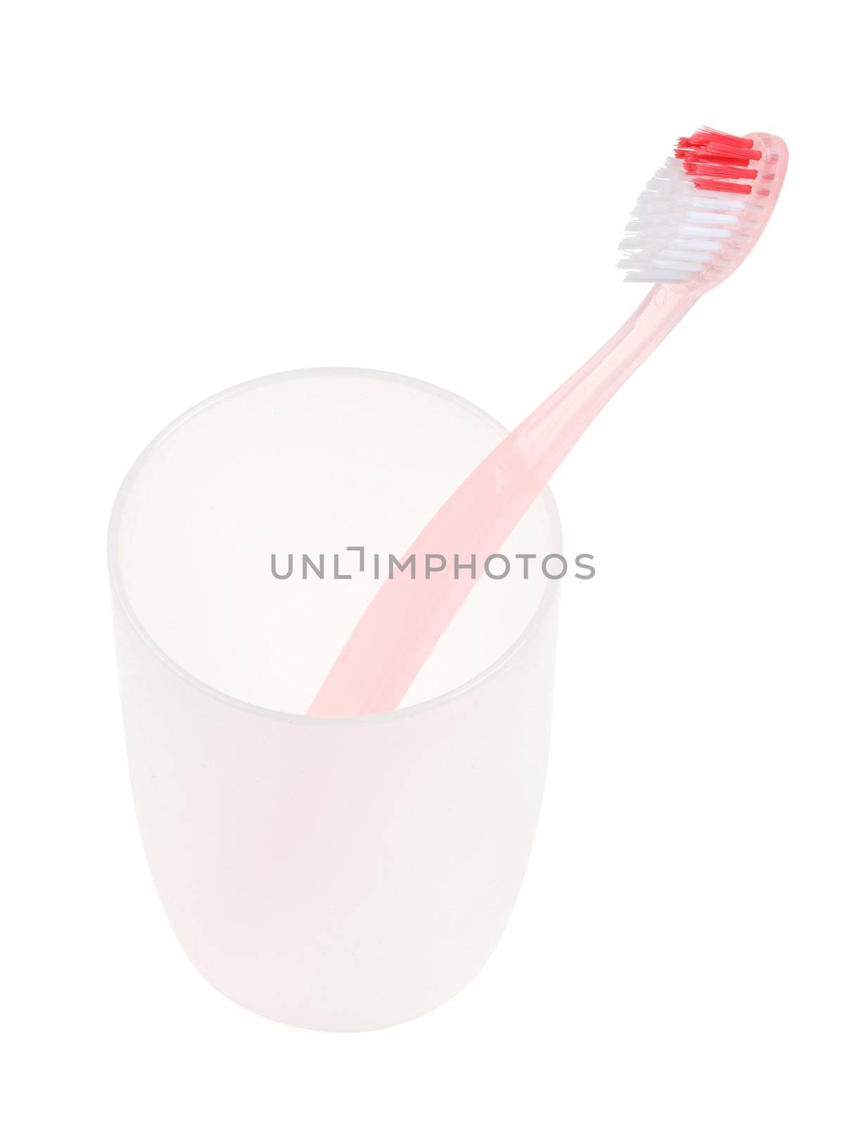 Pink toothbrush in glass. With clipping path.