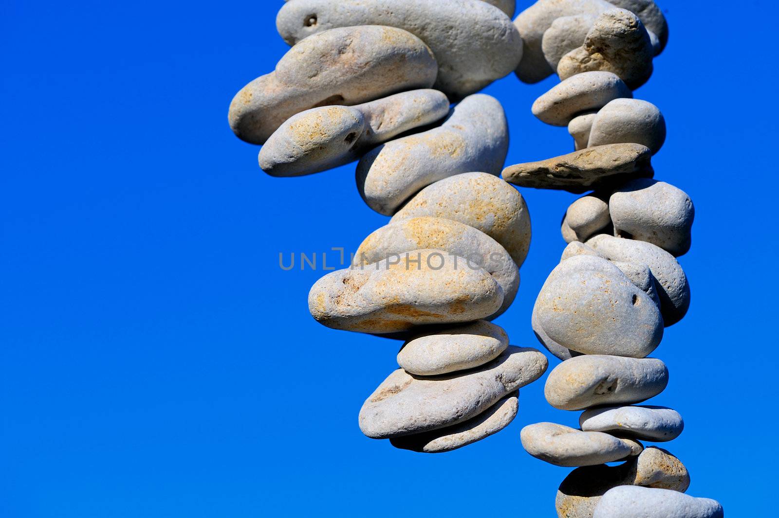 Sea pebbles hanging in the air of a blue sky