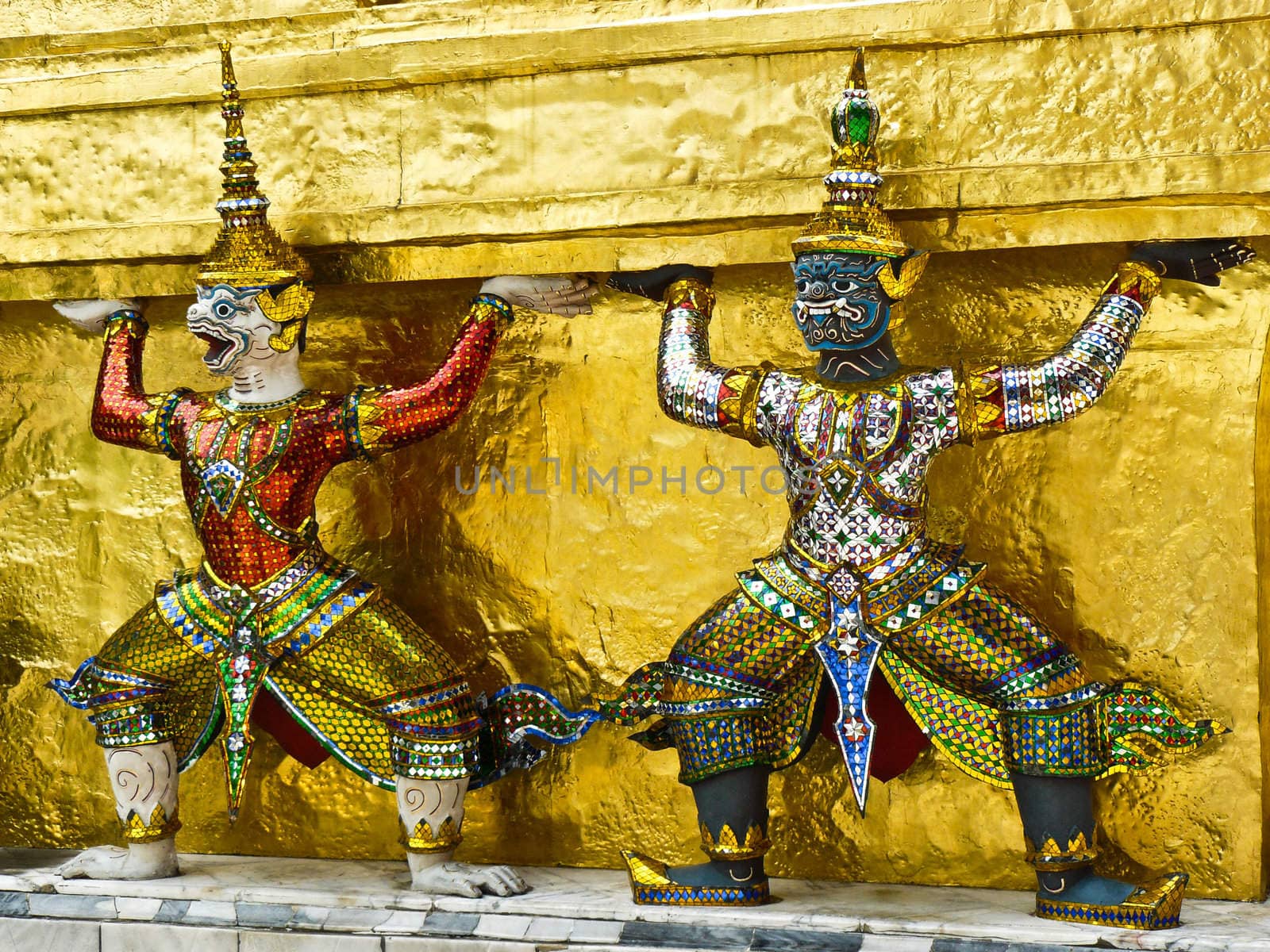 Statue of demon guardians at the Buddhist temple of Wat Phra Kaeo at the Grand Palance in Bangkok, Thailand.