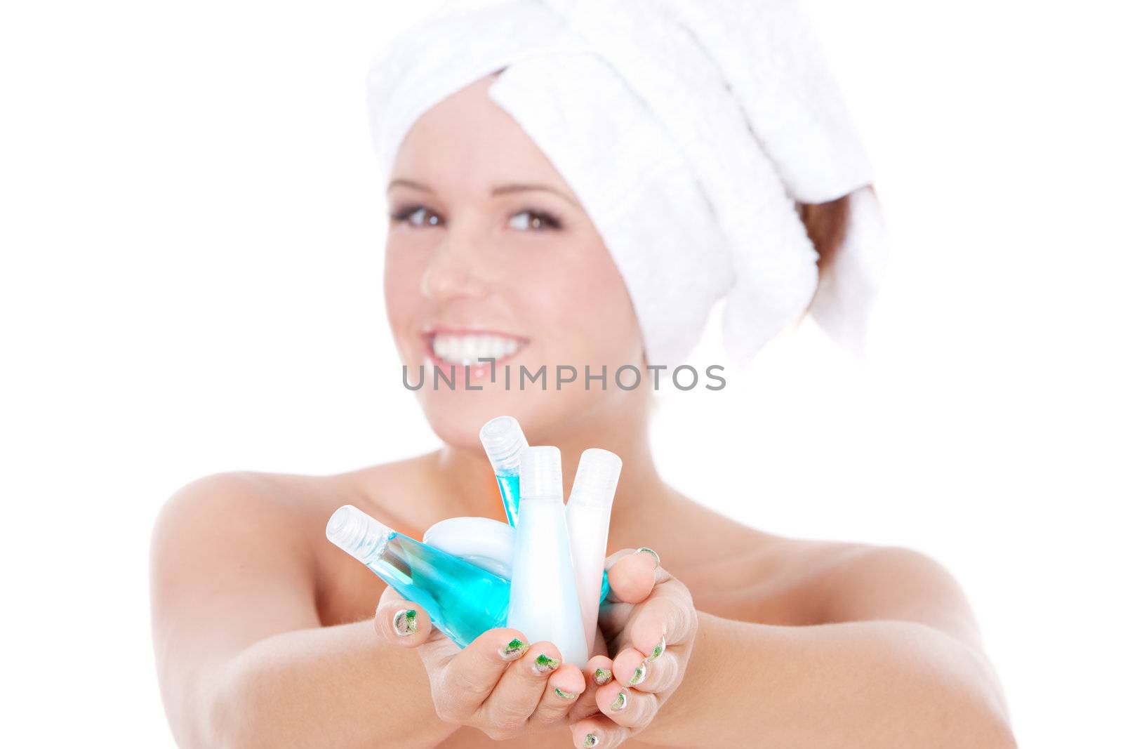 Spa woman holding bottles with shampoo. Focus on hands.
