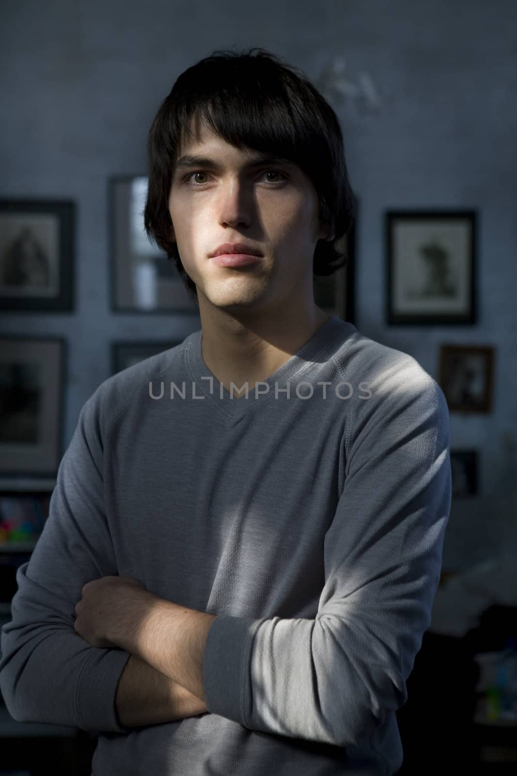 close up portrait of young serious handsome man standing in the middle of the room.