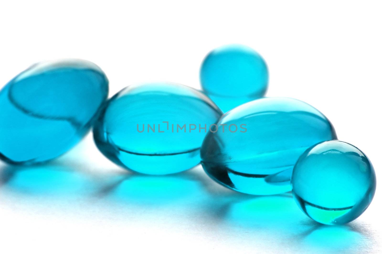An abstract picture of vitamins pills in cyan color