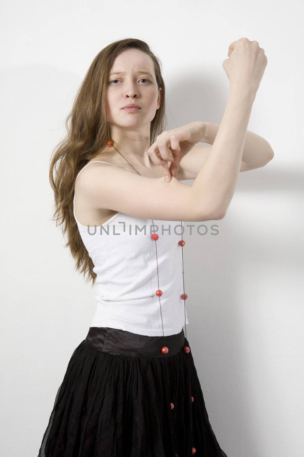 angry woman with beads showing her biceps. isolated on white


