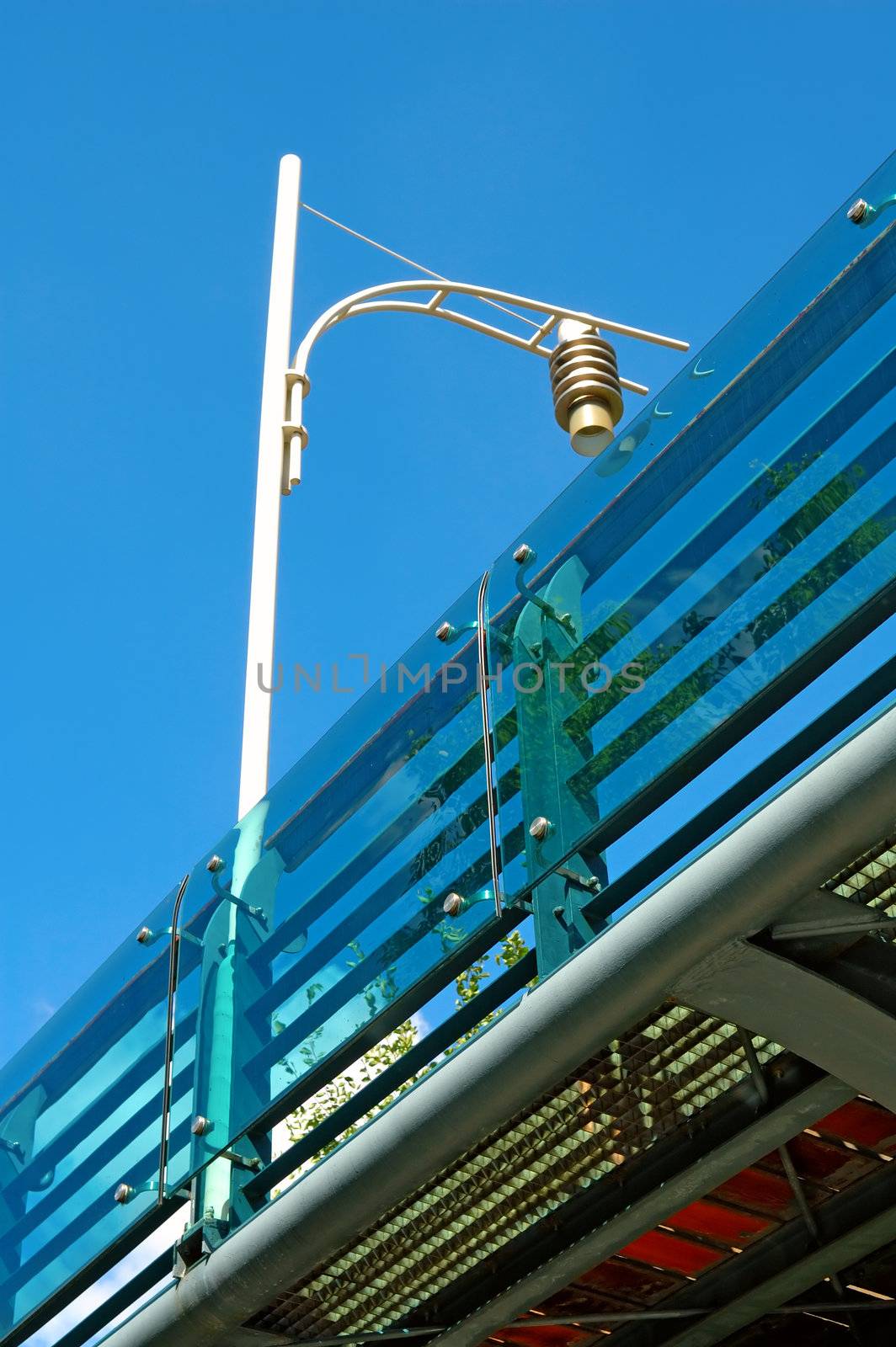 The partial of over bridge and a lamp post from bottom