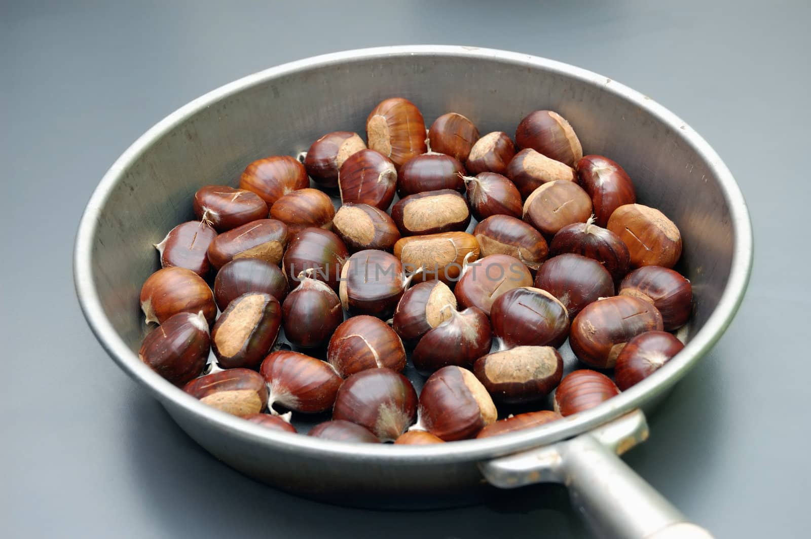 roasting chestnut in a typical italian pan