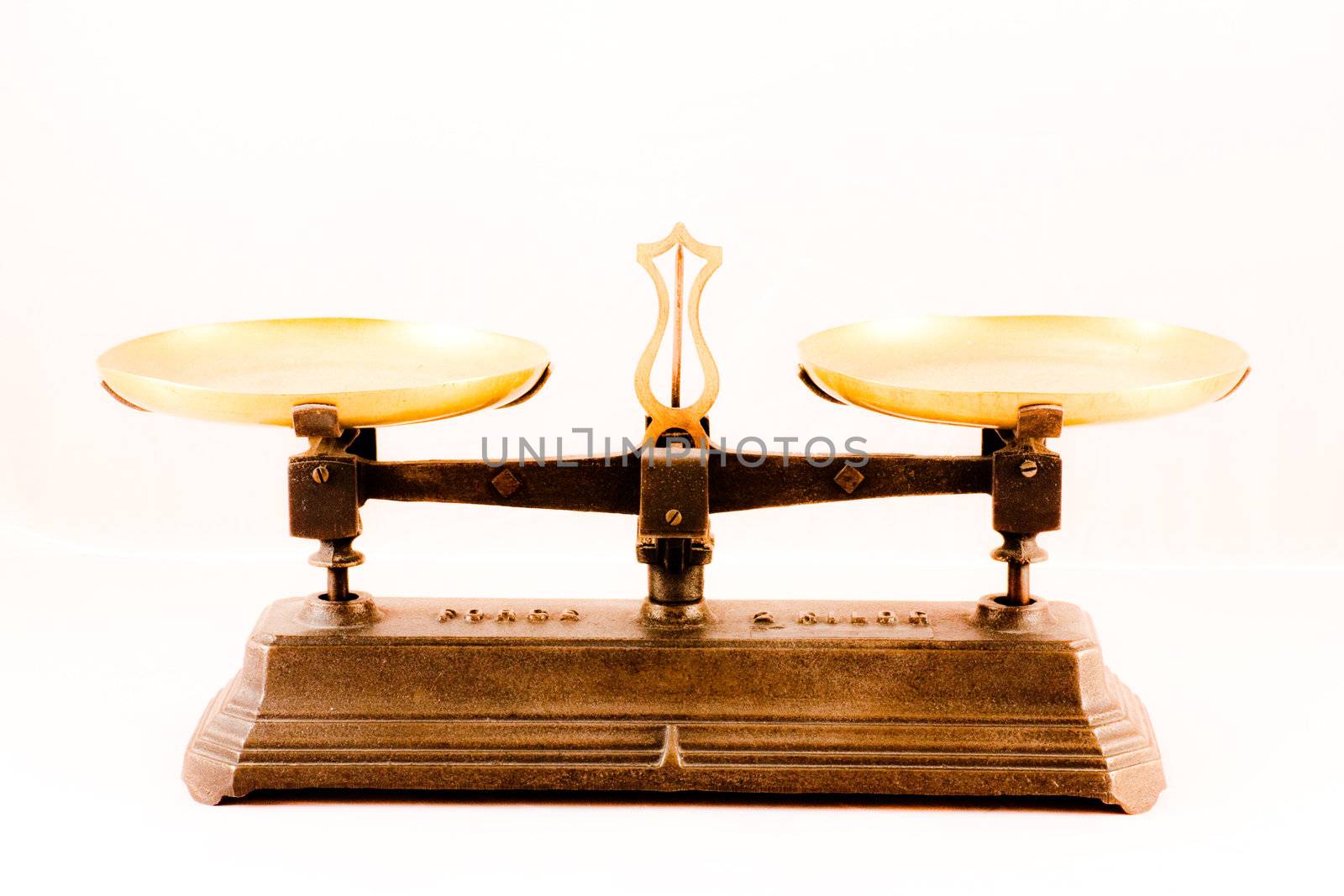 An antique scale on white background, useful for conceptual