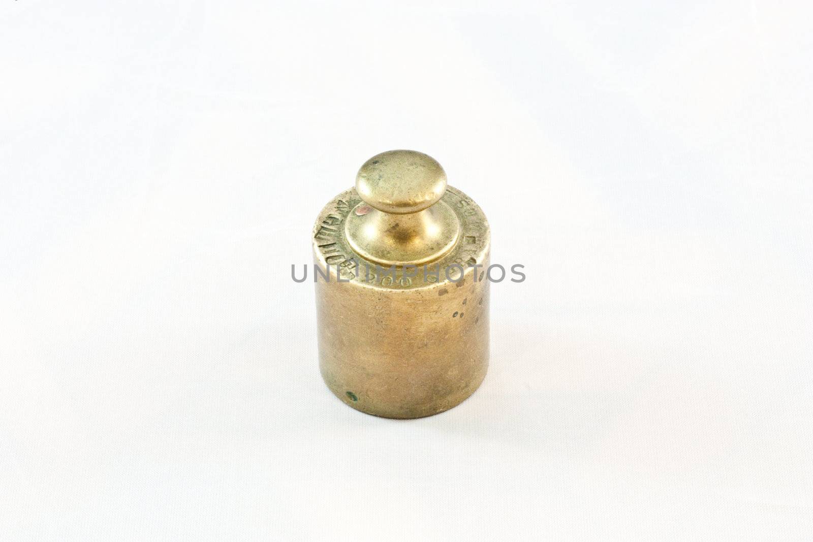 An antique iron weight on white background, useful for conceptual