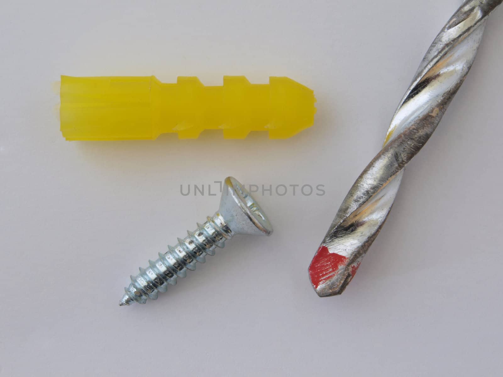 Drill bit with a screw and raw plug