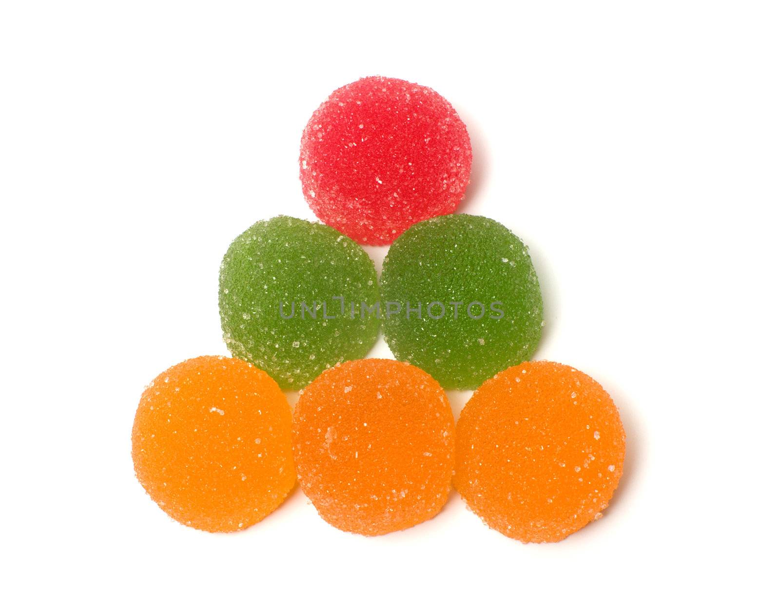 Triangle from color fruit candy on a white background.