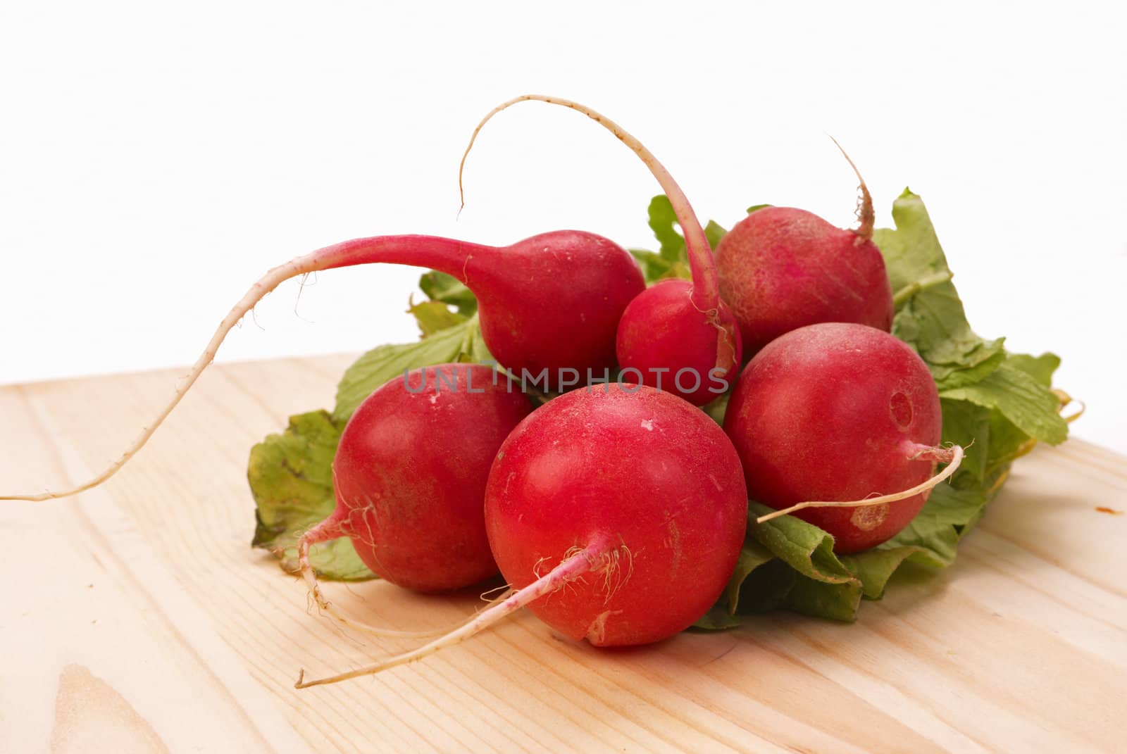 Bunch of fresh red radish on a chopping board