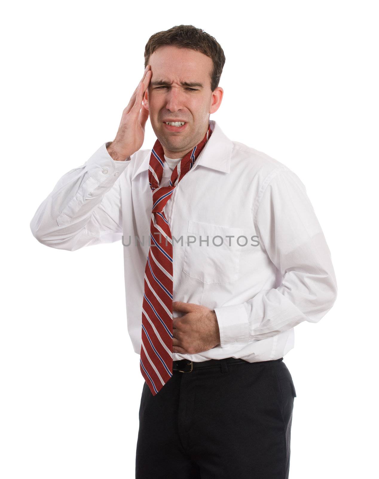 A young man wearing a suit and tie is suffering from a stomach ache and a headache at the same time, isolated against a white background