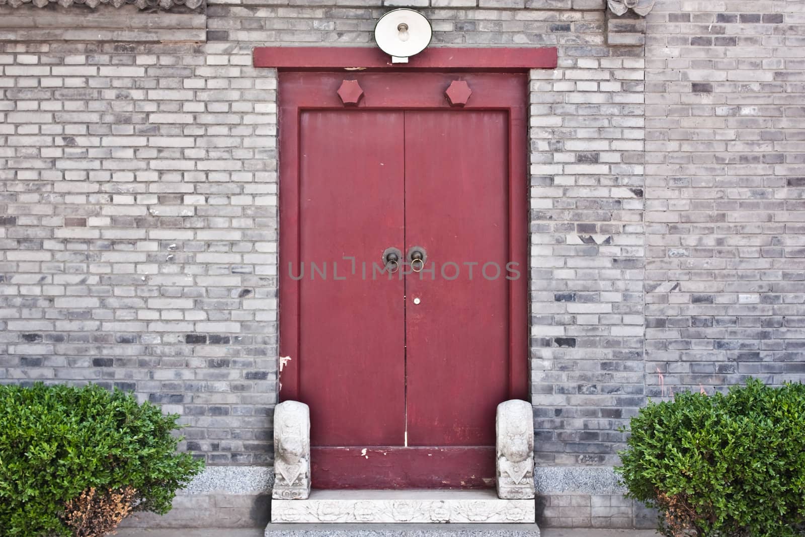 Red door in hutong area, close to Forbidden City, Beijing, China