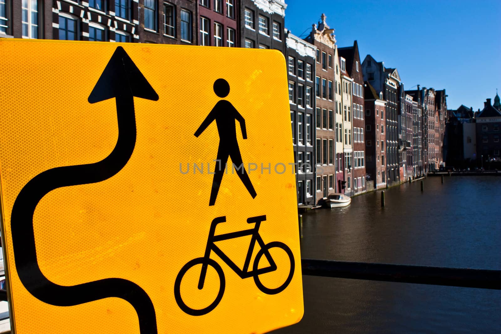 Amsterdam canal view with sign for bicycle, close to the center of the city