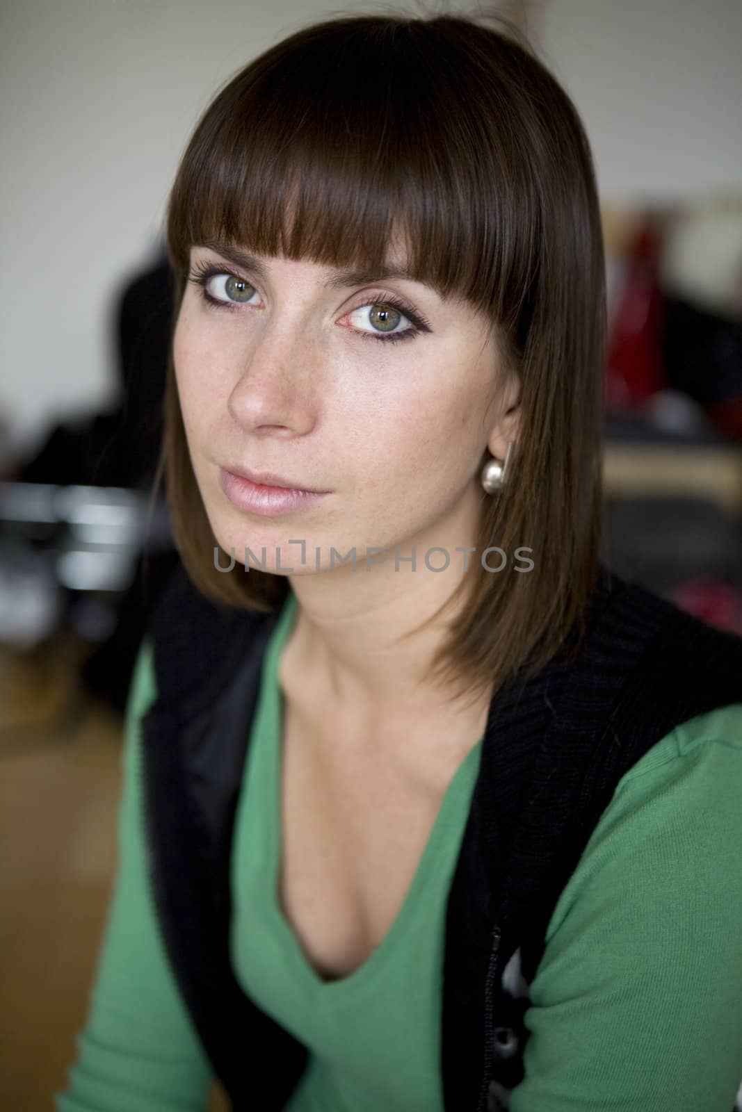 portrait attractive brunette pensive woman wearing green blouse